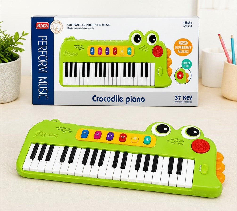 Teclado infantil Fastrok con diseño de cocodrilo verde, 37 teclas, luces LED y funciones musicales educativas.